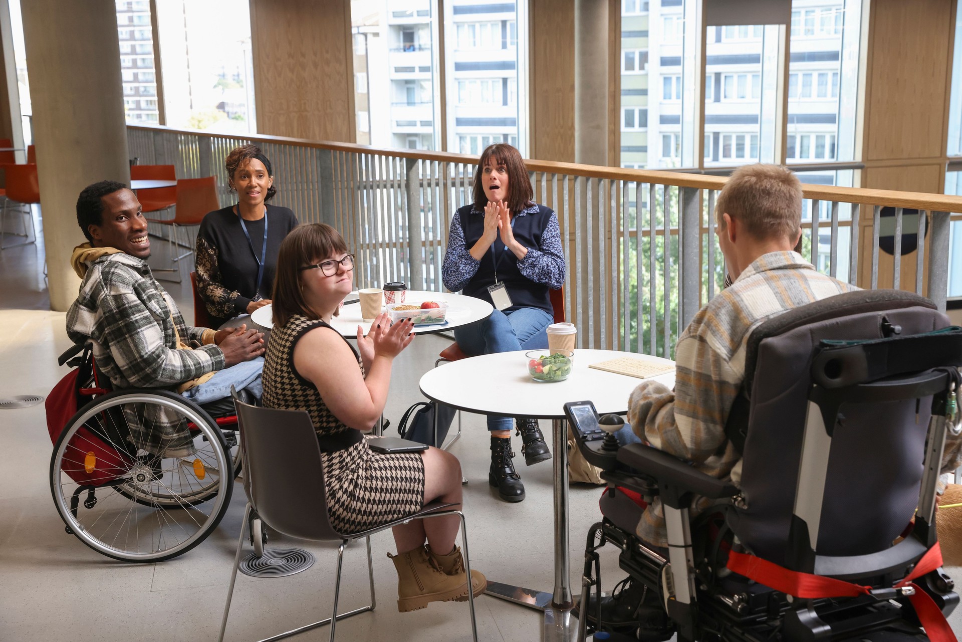 Disabled people talking at tables