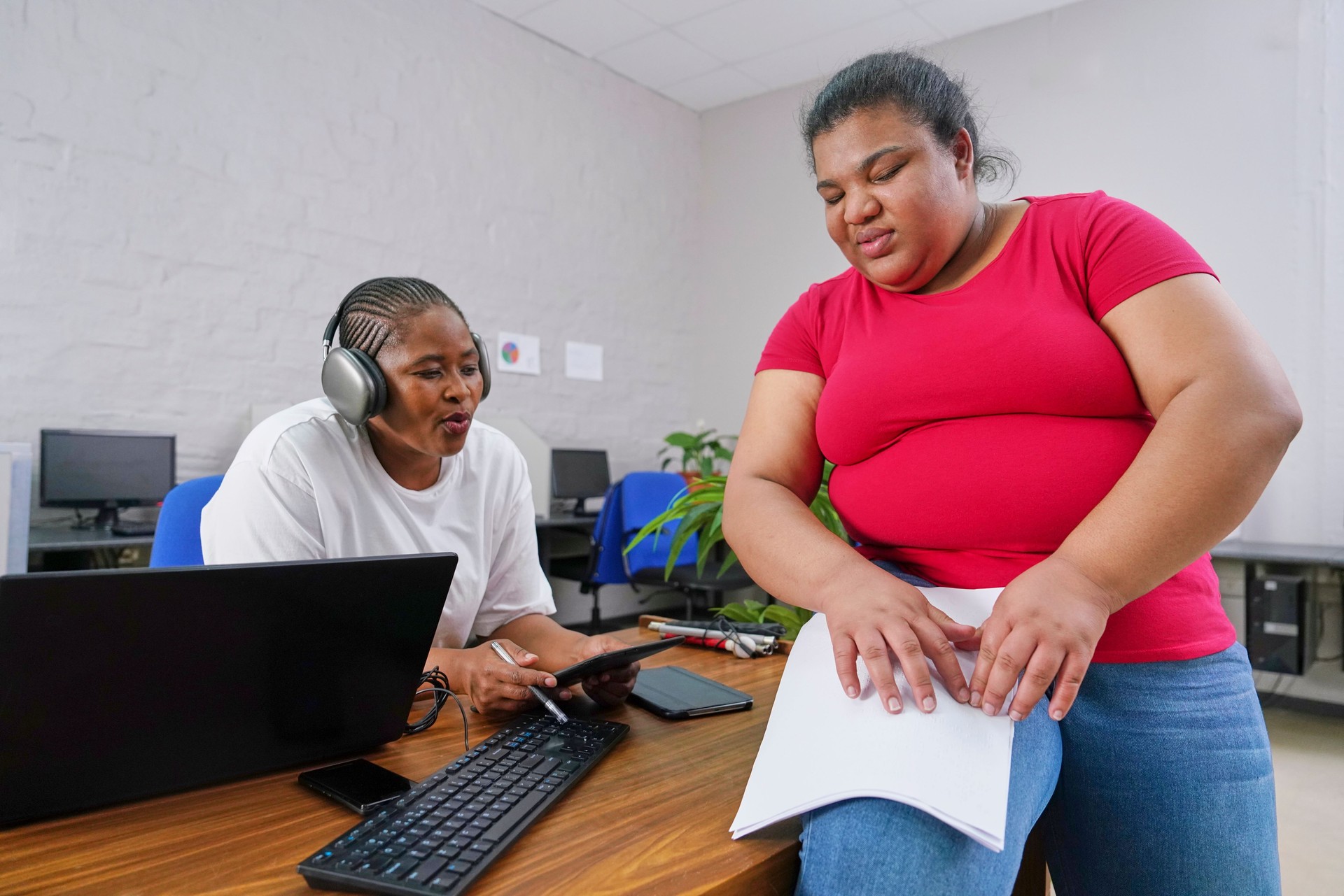 Two businesswomen working at desk in office